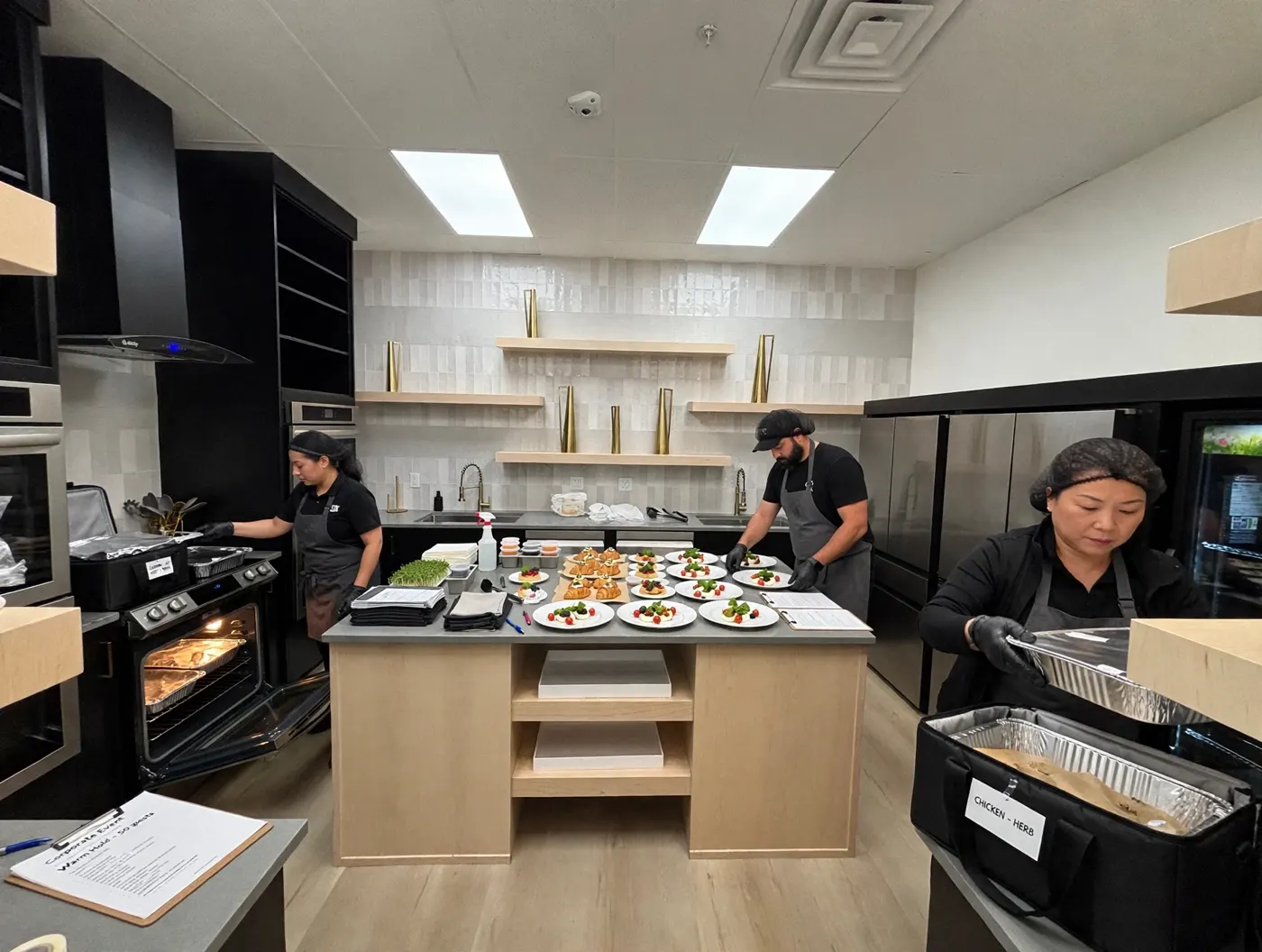 Catering staff plating hors d'oeuvres in The Hive's kitchen for a corporate event
